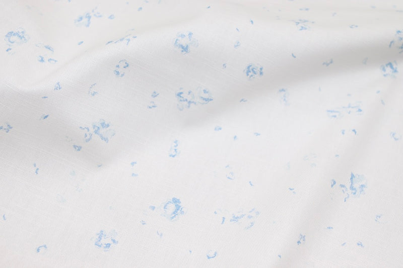 our 'Ditsy Field' print in blue printed on linen as part of our Faded Floral Linen Fabrics collection