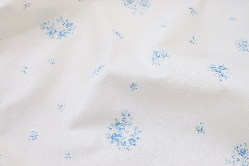 Petite Fleur Bleu design printed on fine oyster linen as part of our Faded Floral Linen Fabrics 