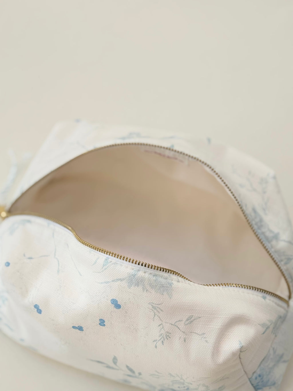 Floral-patterned bra with a zipper on a beige background